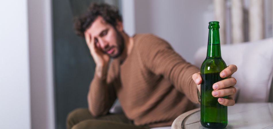 man in alcohol bottle in hand