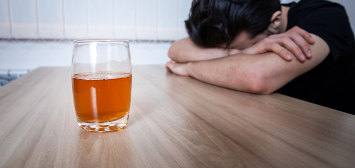 Depressed man lying on table